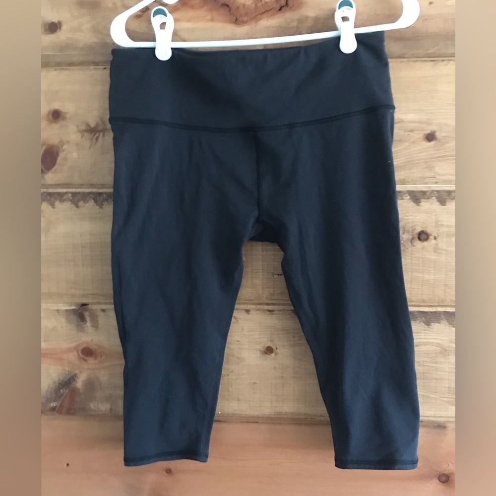 Good used condition Lululemon cropped knee leggings with net cutouts on sides.